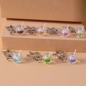 Close-up of star-shaped metal clips and colorful glowing drink bottle keychains
