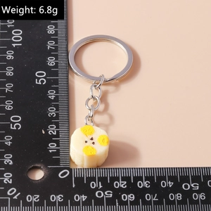 Detailed macro view of a 6.8g realistic food keychain with a banana slice resin pendant