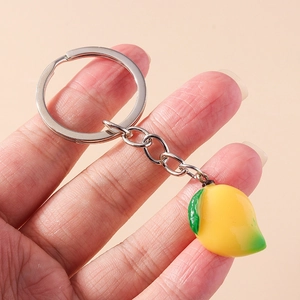 Realistic mango keychain pendant with yellow-green gradient resin on pink background
