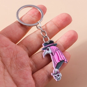Detailed macro view of acrylic plague doctor keychain held in hand for size visualization