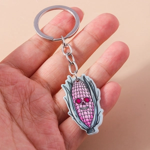 Macro shot of Halloween acrylic corn skull keychain with pink detailing and silver ring