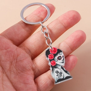Detailed macro shot of Day of the Dead acrylic keychain with sugar skull lady and red roses