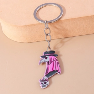 Detailed view of Plague Doctor keychain with beak mask on a pink sponge display stand