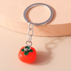 Detailed view of creative orange persimmon keychain pendant with silver metal ring