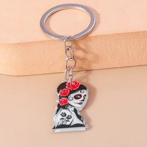 Macro detail of acrylic Day of the Dead keychain with red rose and skull design