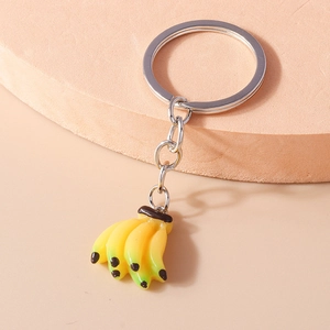 Detailed close-up of a realistic banana cluster keychain with natural yellow-green gradients