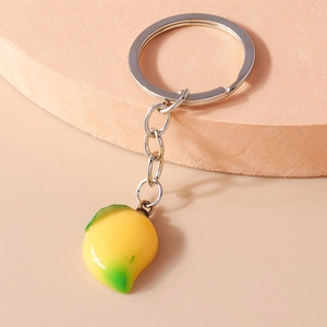 Detailed macro view of a realistic artificial mango keychain with a glossy yellow gradient