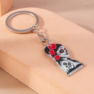 Detail of Halloween keychain with Day of the Dead skull girl and red roses pattern