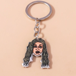 Creative cartoon female portrait acrylic keychain with silver metal ring on beige background