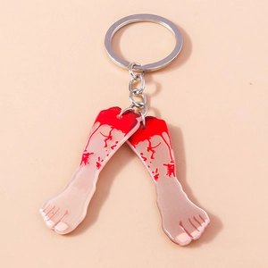 Detail view of Halloween acrylic keychain featuring severed foot design with red blood splatters