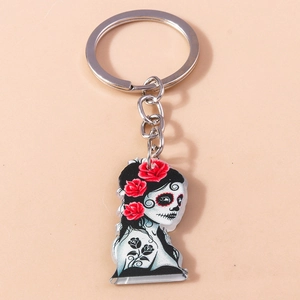 Detail of acrylic Day of the Dead skeleton keychain with vibrant red roses