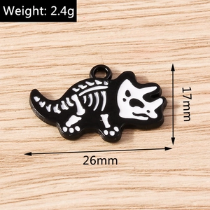 Detail view of a black and white triceratops skeleton charm with 26mm by 17mm dimensions