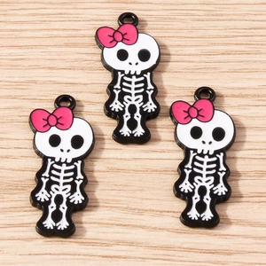 Detail of creative skull girl charms with pink bows for DIY jewelry making