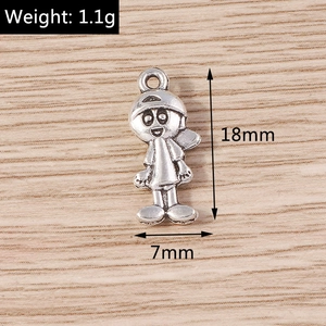 Detailed macro view of small boy charms in antique silver alloy for DIY jewelry crafting