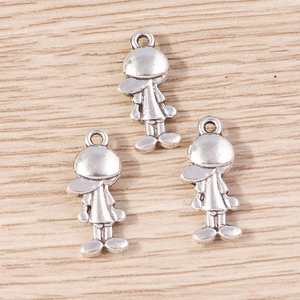 Close-up of three cartoon boy metal charms in silver alloy for DIY jewelry and keychains