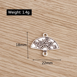 Silver hollow fan pendant with plum blossom relief and double loops for DIY jewelry