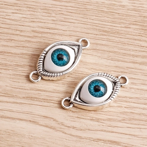 Two silver metal evil eye charms with blue glass inlay and double rings for jewelry making