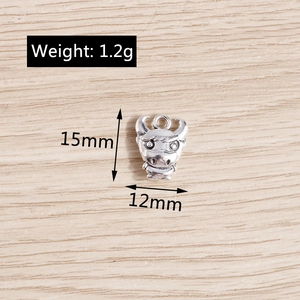 Detailed macro view of an antique silver calf charm with dimensions of 15mm by 12mm