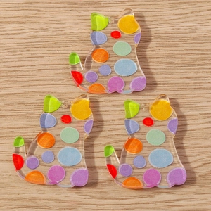 Macro shot of colorful polka dot pattern on semi-transparent acrylic cat charms for DIY