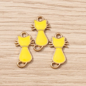Détail de pendentifs chat dorés avec émail jaune pour la création de bijoux DIY
