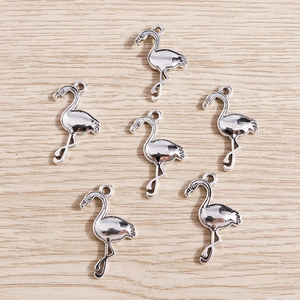 Detailed view of six vintage silver flamingo charms for DIY jewelry making and crafts