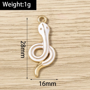 Macro view of a 28mm snake charm with white enamel and gold plating details