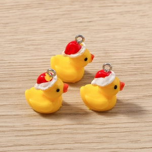 Vue détaillée de trois canards 3D jaunes avec bonnets de Noël rouges sur bois