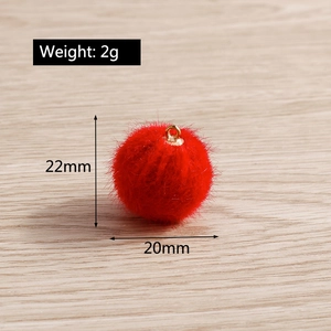 Macro shot of 20mm red faux fur pompom pendant with gold ring for DIY jewelry