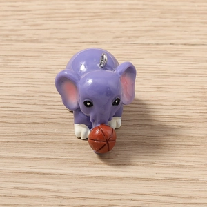 Close-up of purple resin elephant pendant holding a basketball for jewelry making
