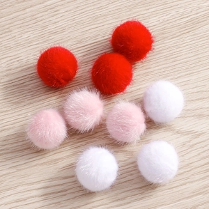 Close-up of soft multi-colored faux fur pompons for DIY jewelry and earring crafts