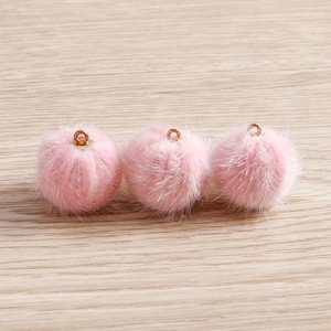 Three soft pink plush pom poms with golden metal rings for DIY jewelry making