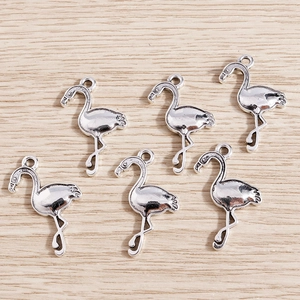 Detailed macro view of six silver flamingo charms for DIY jewelry making and crafting