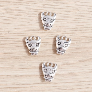 Set of four cartoon cow metal pendants in vintage silver finish for jewelry making