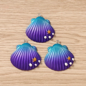 Detailed macro view of shell pendants with blue-purple gradient and pearl accents