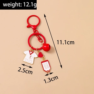 Detail view of medical keychain with nurse uniform, red heart, and blood bag charms