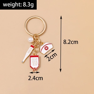 Detailed close-up of nurse hat and thermometer charms on a gold medical keychain