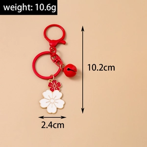 Detail showing dimensions of cherry blossom keychain with red bell and enamel flower charms