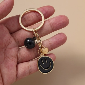 Porte-clés Créatif Cœur Doré et Visage Souriant Noir Alliage avec Cloche Pendentif de Sac Bijoux de Mode pour Femmes