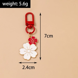 Detailed view of twin cherry blossom keychain with 7cm height and 2.4cm width dimensions