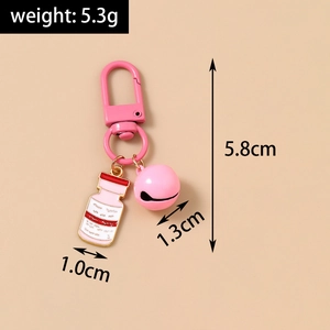 Detailed view of pink cartoon nurse keychain with bell and painted metal clasp