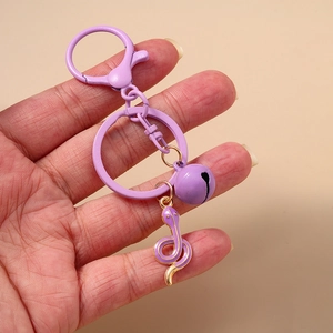 Purple zodiac snake keychain with bell and enamel pendant on a D-ring clasp