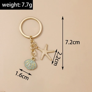 Detail of gold starfish and blue shell keychain showing dimensions and textures