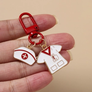 Nurse hat and uniform medical enamel keychain with red carabiner held in hand