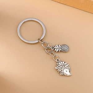 Fashionable hedgehog and pineapple metal keychain set in a vintage silver finish