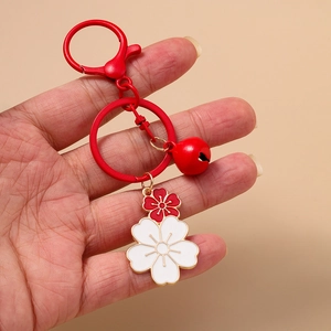Fashionable cherry blossom keychain with red and white floral pendants and small bell charm