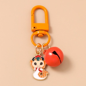 Detail of cartoon snake keychain with red metal bell and orange carabiner clip