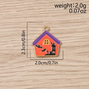 Macro detail of orange Halloween haunted house pendant with purple roof and gold loop charm