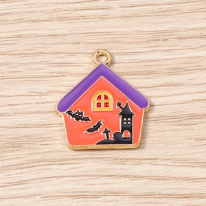 Detail of Halloween castle pendants with orange enamel and bat motifs for DIY jewelry