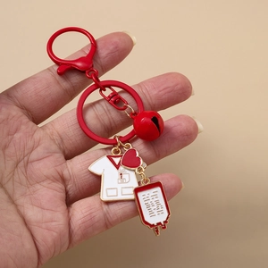 Nurse medical keychain featuring a white coat, red heart, and bell with a large clasp