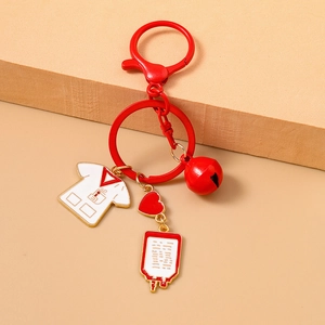 Detailed view of medical charms including nurse uniform and heart pendant on keychain